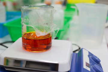 Canvas Print - Experiment chemical solution mixing liquids on a Hotplate Stirrer in Lab.