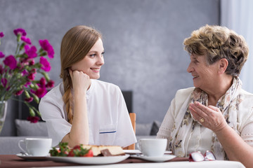 Canvas Print - Senior woman talking with carer