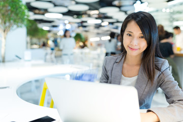 Businesswoman working on laptop computer in co working place