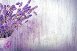 Fototapeta Lawenda - Bouquet of dry lavender in vase with rustic wooden background