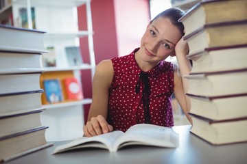 Wall Mural - Attentive schoolgirl studying in library