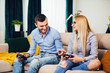 © aboutmomentsimages - Young married couple having fun with modern technology console online, playing videogames and enjoying the weekend