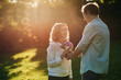 © mavoimages - Smiling woman receiving flowers from her husband outside