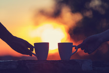 Friends Drinking Coffee In Sunset / Sunrise. Shallow Depth Of Field.