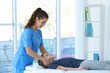 © Africa Studio - Physiotherapist working with patient in clinic