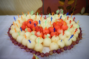 Wall Mural - Balls of melon and watermelong put on sticks made heart on dinner table