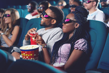 Boyfriend and girlfriend in 3d glasses watching movie in cinema.