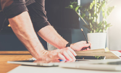 Wall Mural - Close-up of male hand on table. Businessman standing near table, leaning his hands on table.