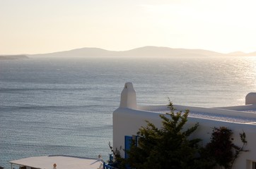 Wall Mural - Evening haze over the sea/Typical architecture near the hotel in Santorini, Greece. Overlooking the Aegean sea. From the trip the Cyclades and the Mediterranean