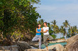 © Santorines - Young couple doing yoga on the beach