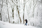 Fototapeta Miasto - Happy couple having fun outdoors in snow park. winter vacation