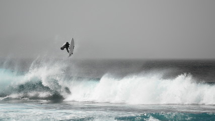 surfer jumping on a wave