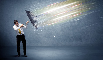 Wall Mural - Business man defending light beams with umbrella concept