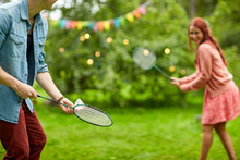 Happy Couple Playing Badminton At Summer Garden
