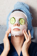 © Parilov - The girl puts and corrects a nutritious mask on a skin with green ripe fresh cucumber. Mask for rejuvenating and eliminating skin defects. Acne
