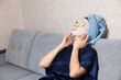 © Parilov - The girl puts and corrects a nutritious mask on a skin with green ripe fresh cucumber. Mask for rejuvenating and eliminating skin defects. Acne
