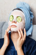 © Parilov - The girl puts and corrects a nutritious mask on a skin with green ripe fresh cucumber. Mask for rejuvenating and eliminating skin defects. Acne