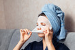 © Parilov - Girl puts a nourishing mask on the skin. Mask for rejuvenating and eliminating skin defects. Acne, acne. Young woman do masking