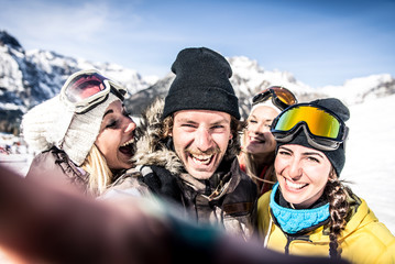 Group of friends having fun on the snow