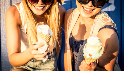 Two friends eating ice cream outdoor