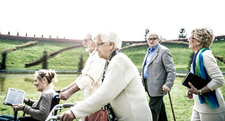 Wall Mural - Group of seniors walking in the park