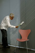 © STOCK4B  - Senior man cleaning the wall with a small broom