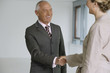 © STOCK4B  - Elderly manager and business woman shaking hands, in high spirits