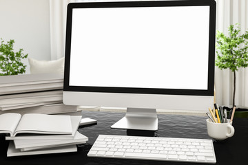 Poster - Front view of workpark with blank white computer screen, coffee cup, and book in home work. Mock up , 3D render