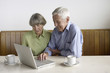 © STOCK4B  - Senior adult couple sitting in front of a laptop