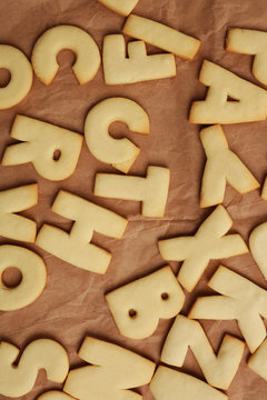 Cookie alphabet on crumpled paper, closeup