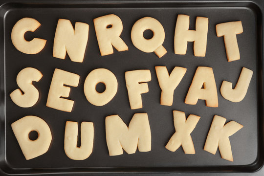 Cookie alphabet on baking tray, closeup