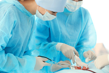 Canvas Print - Young doctors operating patient in clinic