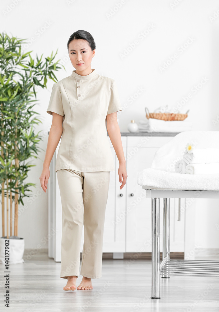 Young Asian masseur in spa salon