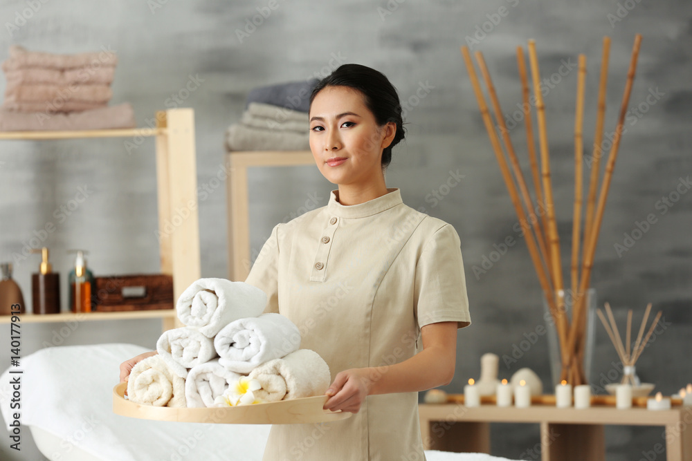 Young Asian masseur in spa salon