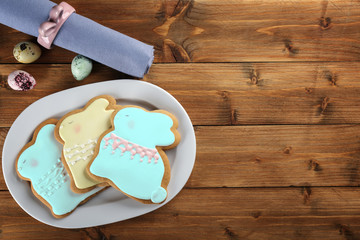 Wall Mural - Beautiful glazed Easter cookies on wooden table