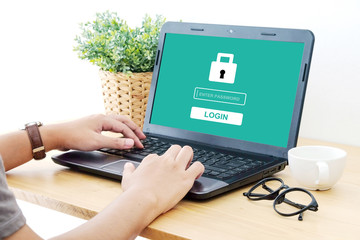 Man typing password on labtop screen background, cyber security concept