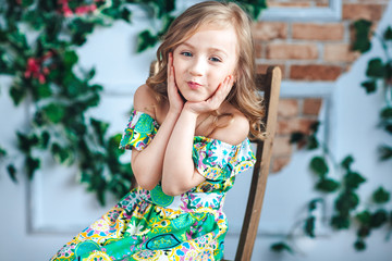 Close-up of a little blonde girl looking and laughing