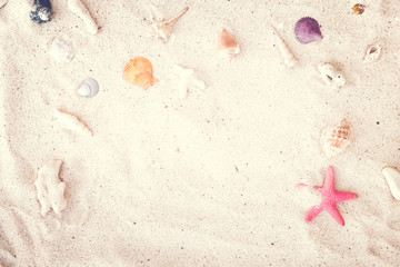 Top view of Beach sand with shells and starfish. summer background concept. vintage tone.