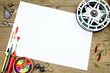 mockup frame fishing tackles and fishing baits in box on wooden board background.