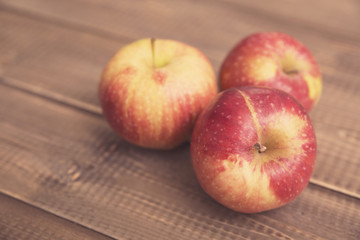 Red apples on a wooden table
