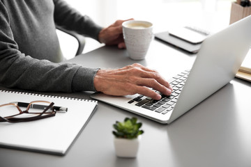 Man working with laptop in room