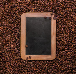 Wall Mural - Vintage slate chalk board on coffee beans background with copy space. Texture. Roasted Arabic coffee. top view. Coffee time.