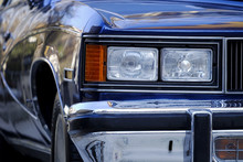 Front View And Headlight Detail Of A Classic American Car
