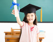 © Tom Wang - Portrait of  cute schoolgirl with graduation hat in classroom