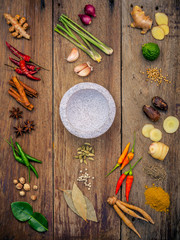 Poster - Various of Indian spices and herbs. Cooking ingredients and red curry paste . Ingredients of thai popular food on rustic wooden background. All spices with flat lay.