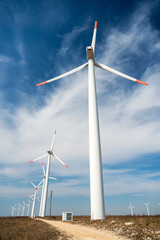 Wind turbines  against a blue sky generating electricity