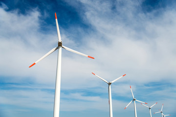 Wind turbines  against a blue sky generating electricity