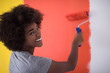 black woman painting wall