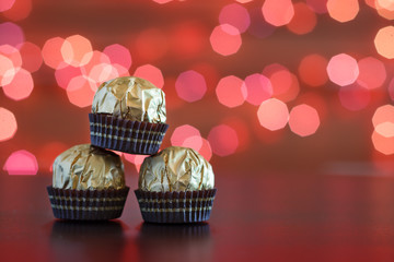 The wrapped candies closeup on background of festive lights.