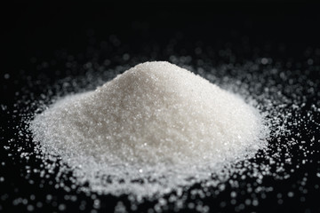 sugar pile on black background, closeup photo